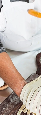 Chef dusting fresh pasta with flour