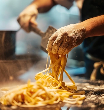 Chef pulling fresh tagliatelle by hand